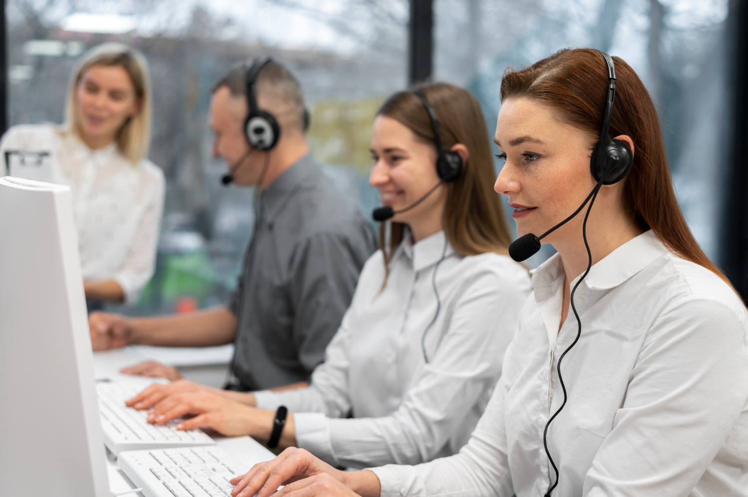 colleagues-working-together-in-a-call-center-with-headphones